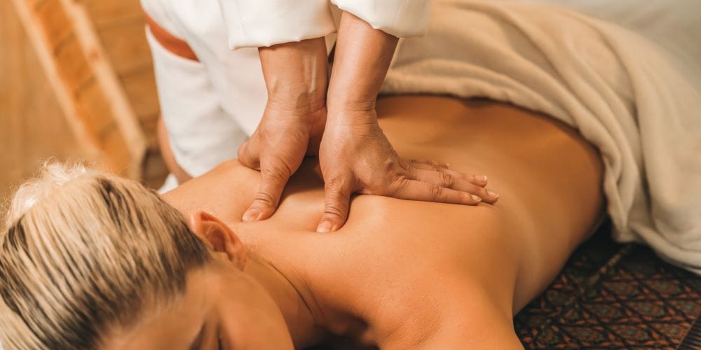 Woman receiving a back massage at a day spa.